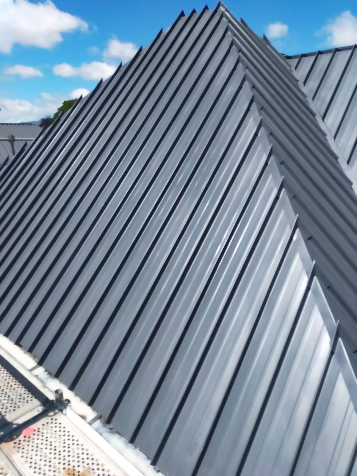 Freshly painted light grey corrugated iron roof by Garden City Painters Christchurch
